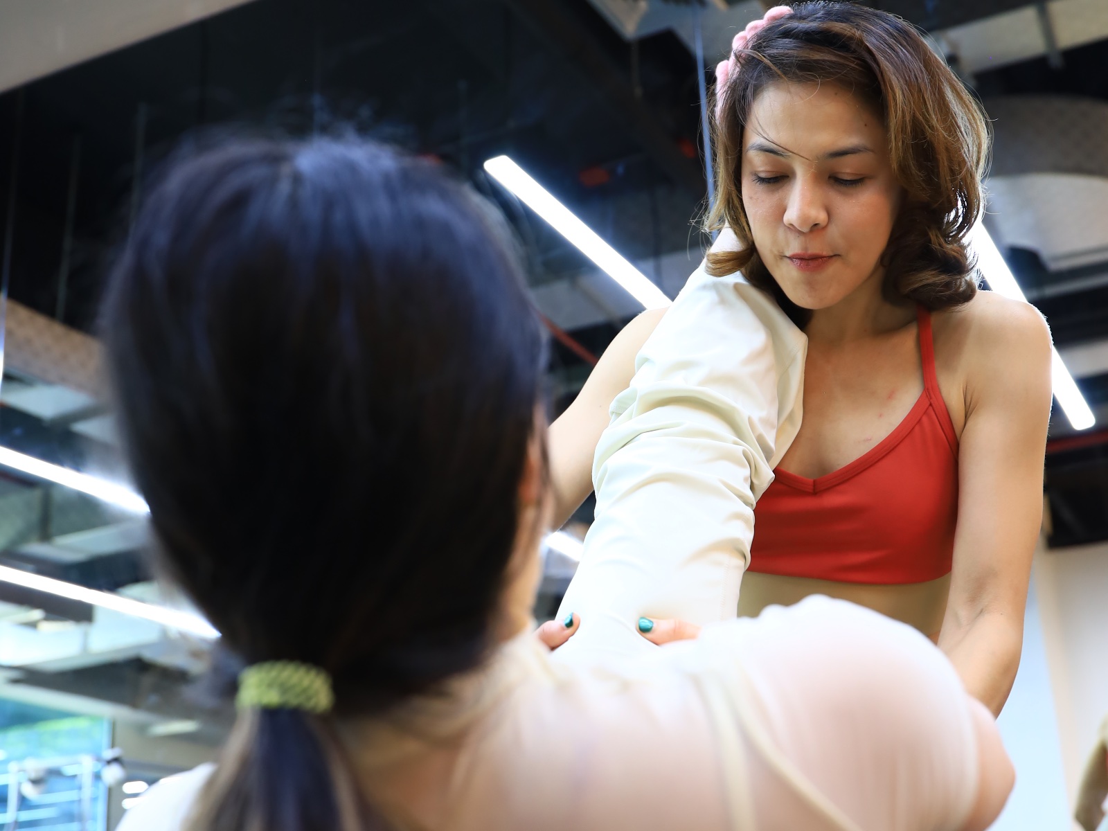 Kru Kaew guiding a student on the apparatus