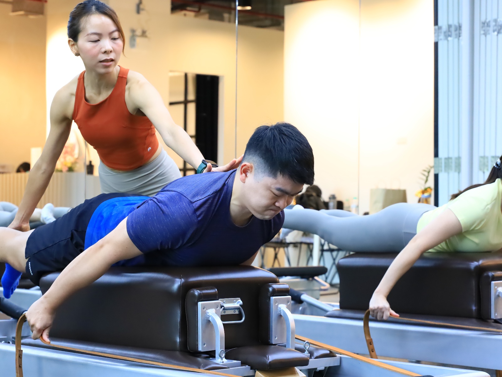 Kru Ple with hands-on adjustment during a movement